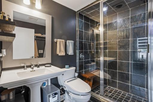 Primary ensuite features tiled walk-in shower with dual shower heads.