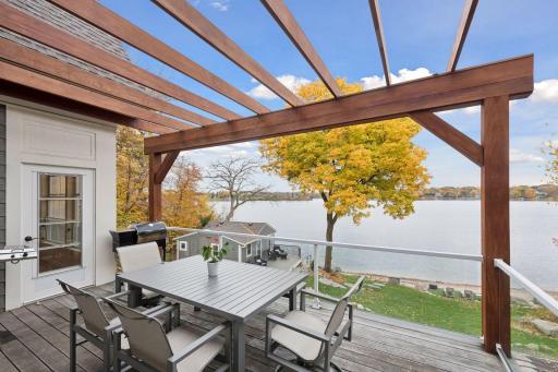 Elevated deck off kitchen ideal for outdoor dining or a sunset happy hour while overlooking the lake