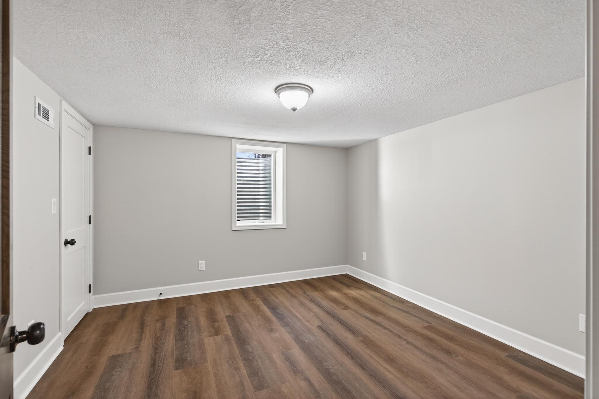 The fourth bedroom, located on the lower level, is ideal for guests, older children, an at home office, and more!