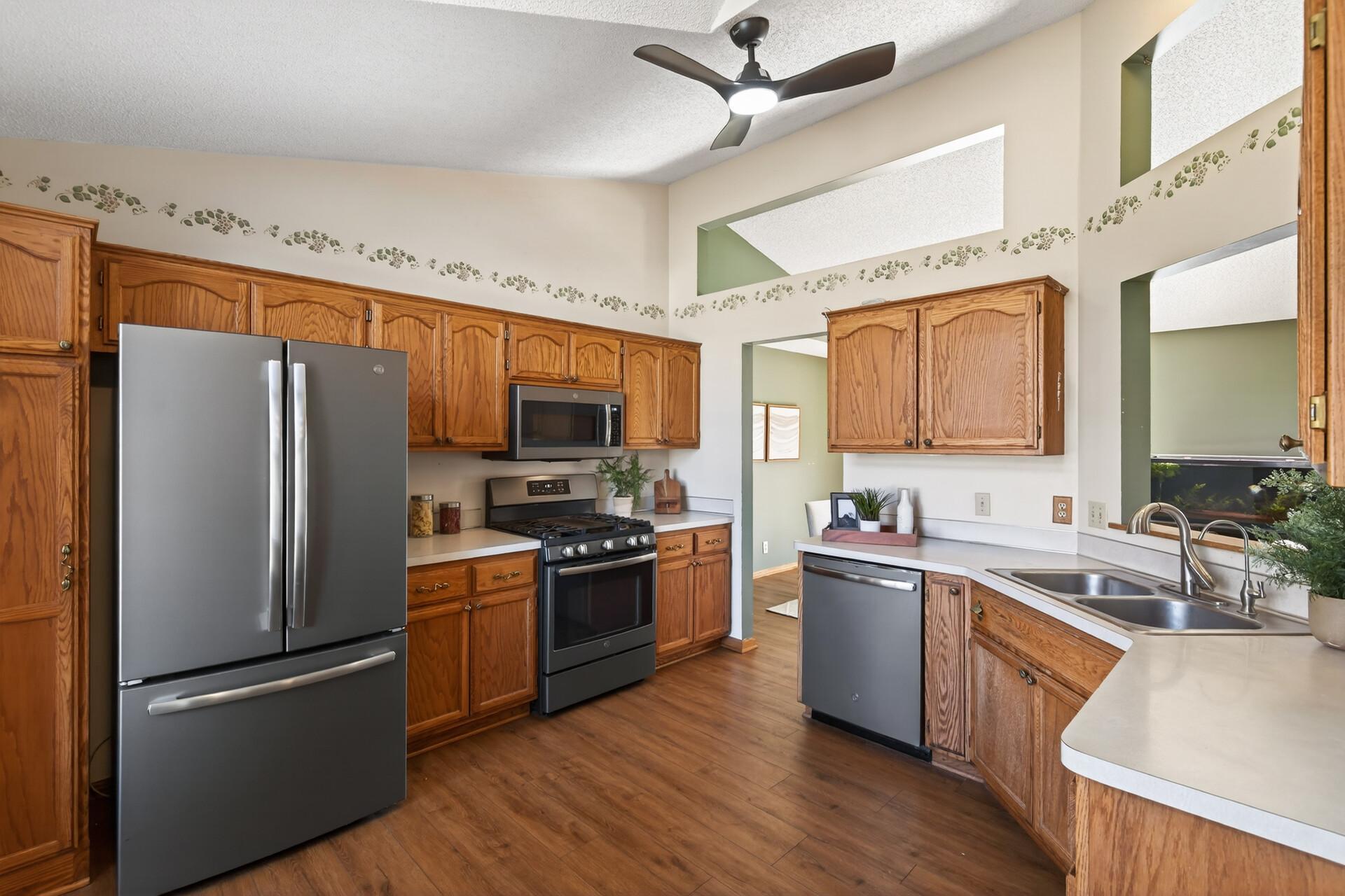 Rich wooden cabinetry is perfectly complemented by the LVP flooring.