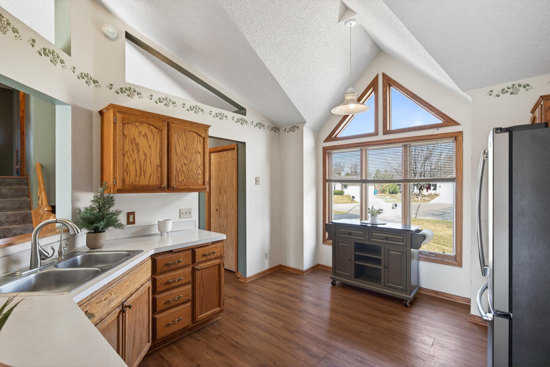The kitchen boasts a charming bay window and plenty of storage/prep space!