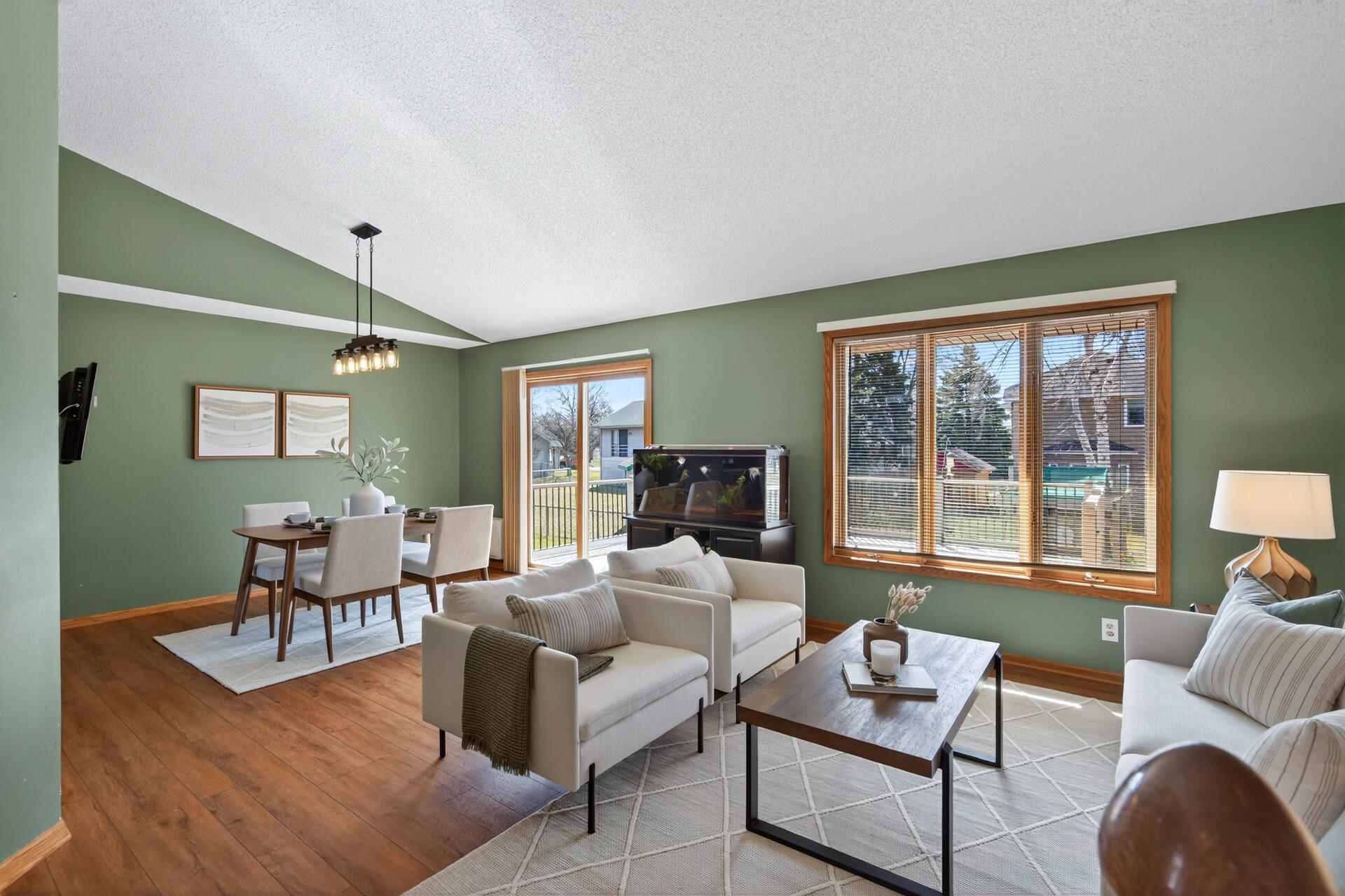 The main level offers soaring vaulted ceilings, LVP flooring, and updated light fixtures for a modern feel.