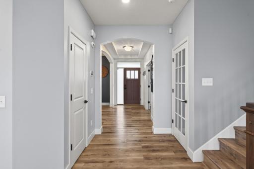 Front door and main hallway showing the formal dining room on the left and the office on the right