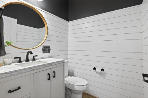 Convenient main floor 1/2 bathroom tucked away by the garage entrance