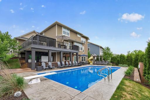 Backyard oasis with pool, hot tub, playset and multiple spaces to hang out or entertain