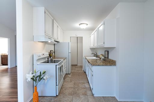 4548 Cedar Lake Rd S _ Bright galley kitchen with abundant cabinetry and efficient layout.