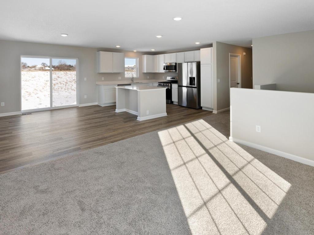 Open Layout. Photo taken of another home with similar plan and finishes. Photos and renderings may not depict actual plan, materials, & finishes may vary. All measurements are approximate.