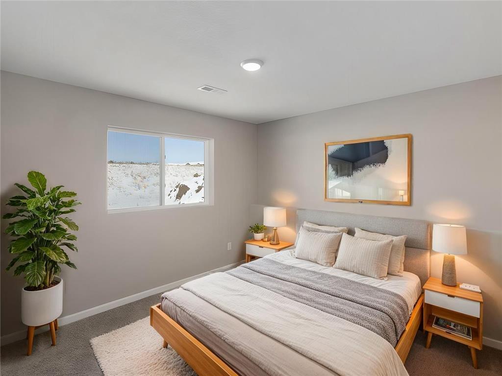 Finished Lower Level Bedroom 3, Virtually Staged. Photo taken of another home with similar plan and finishes. Photos and renderings may not depict actual plan, materials, & finishes may vary. All measurements are approximate.