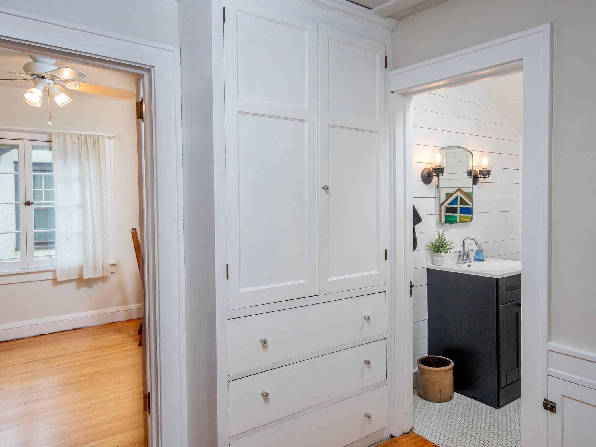 Upstairs hallway features built-in shelves for convenient extra storage and added character!