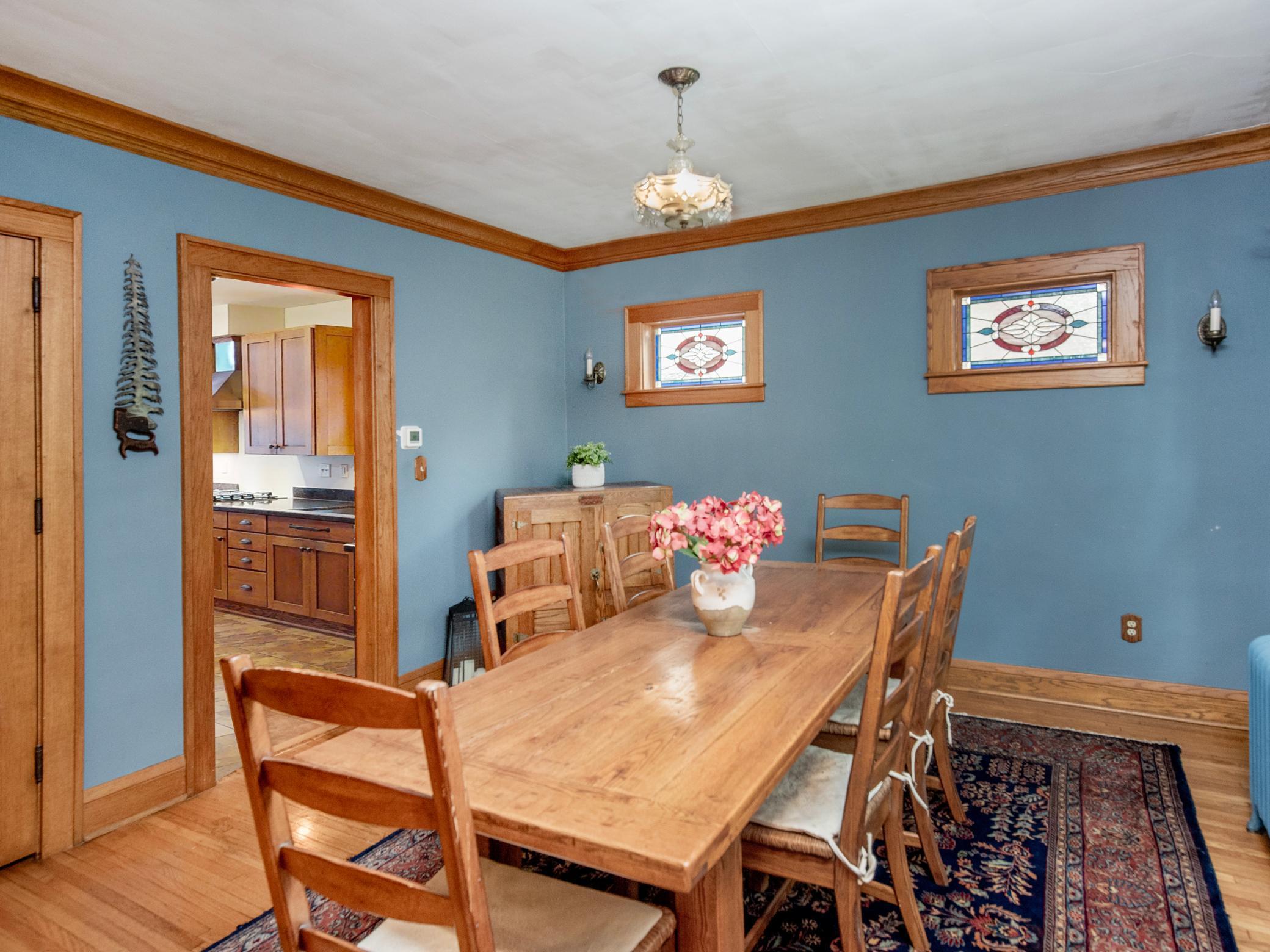 Formal dining room featuring stunning stained glass accent windows.