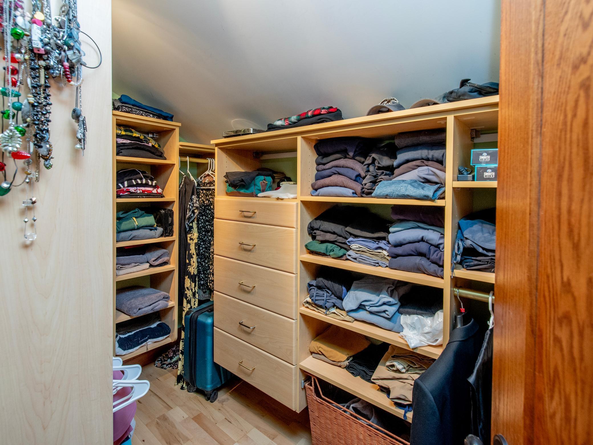 Large primary walk-in closet with built-ins for easy organization.