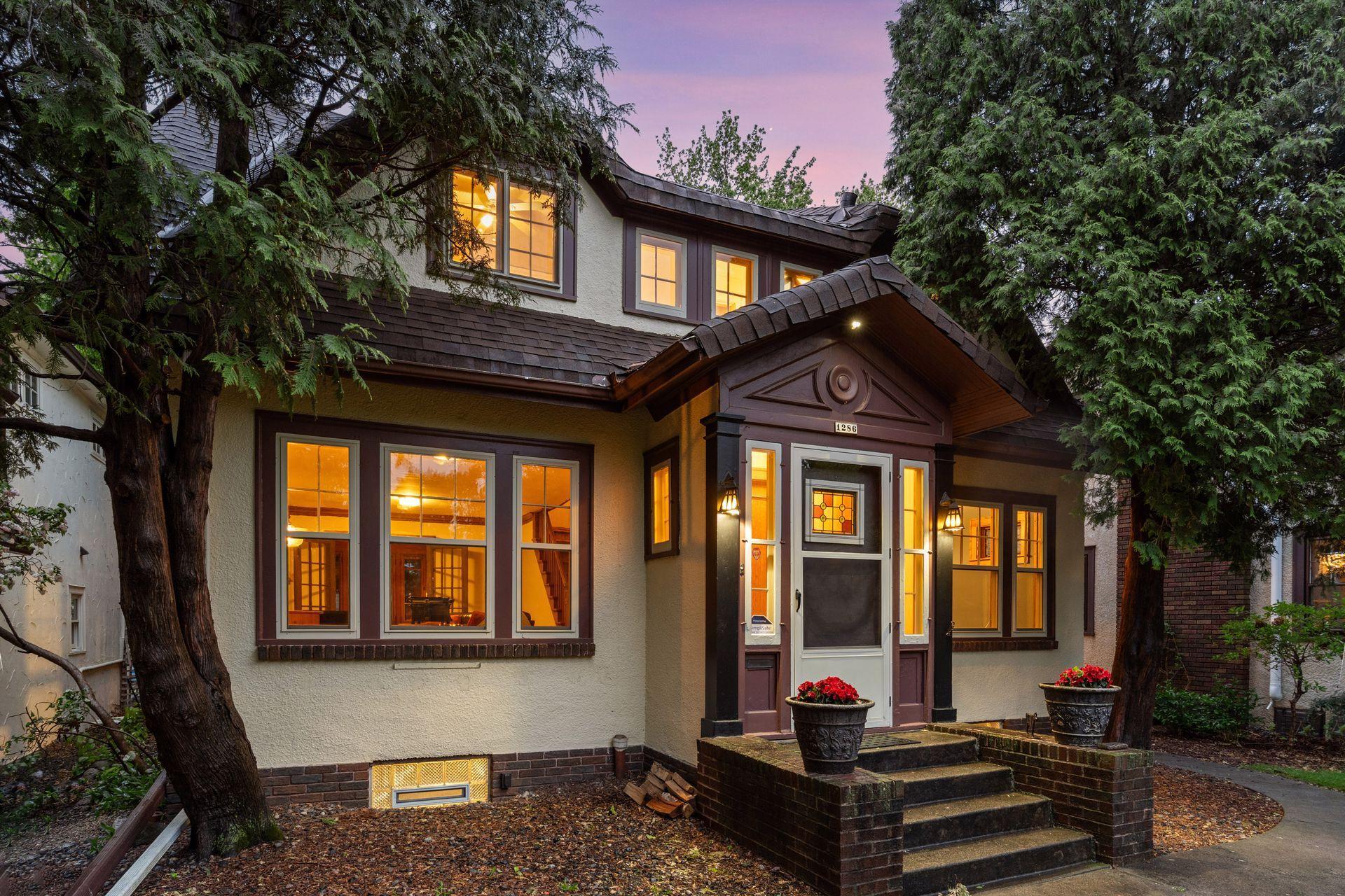 A welcoming front walkway framed by mature trees.