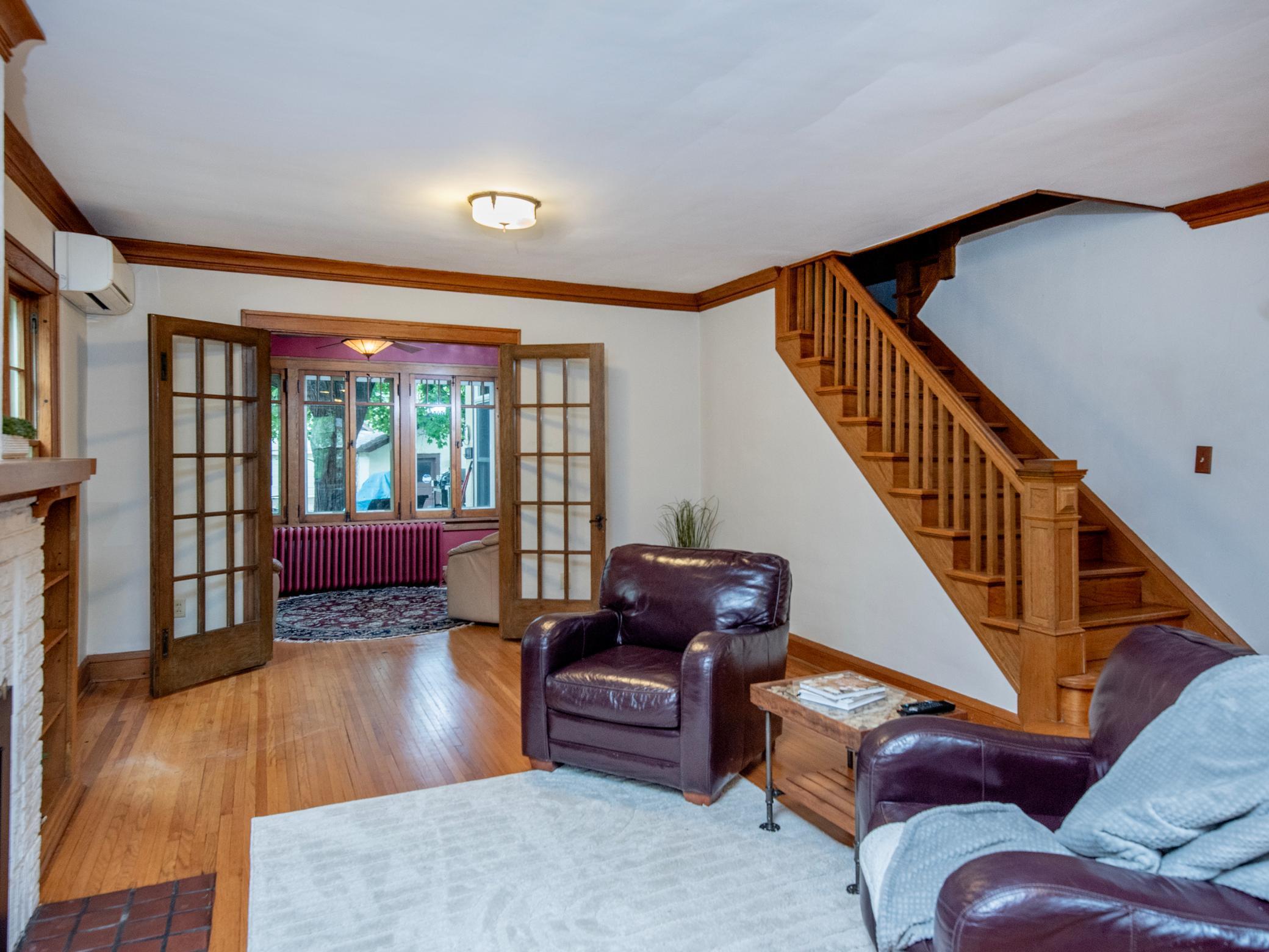 Step through charming French doors into a cozy sunroom just off the main living area.
