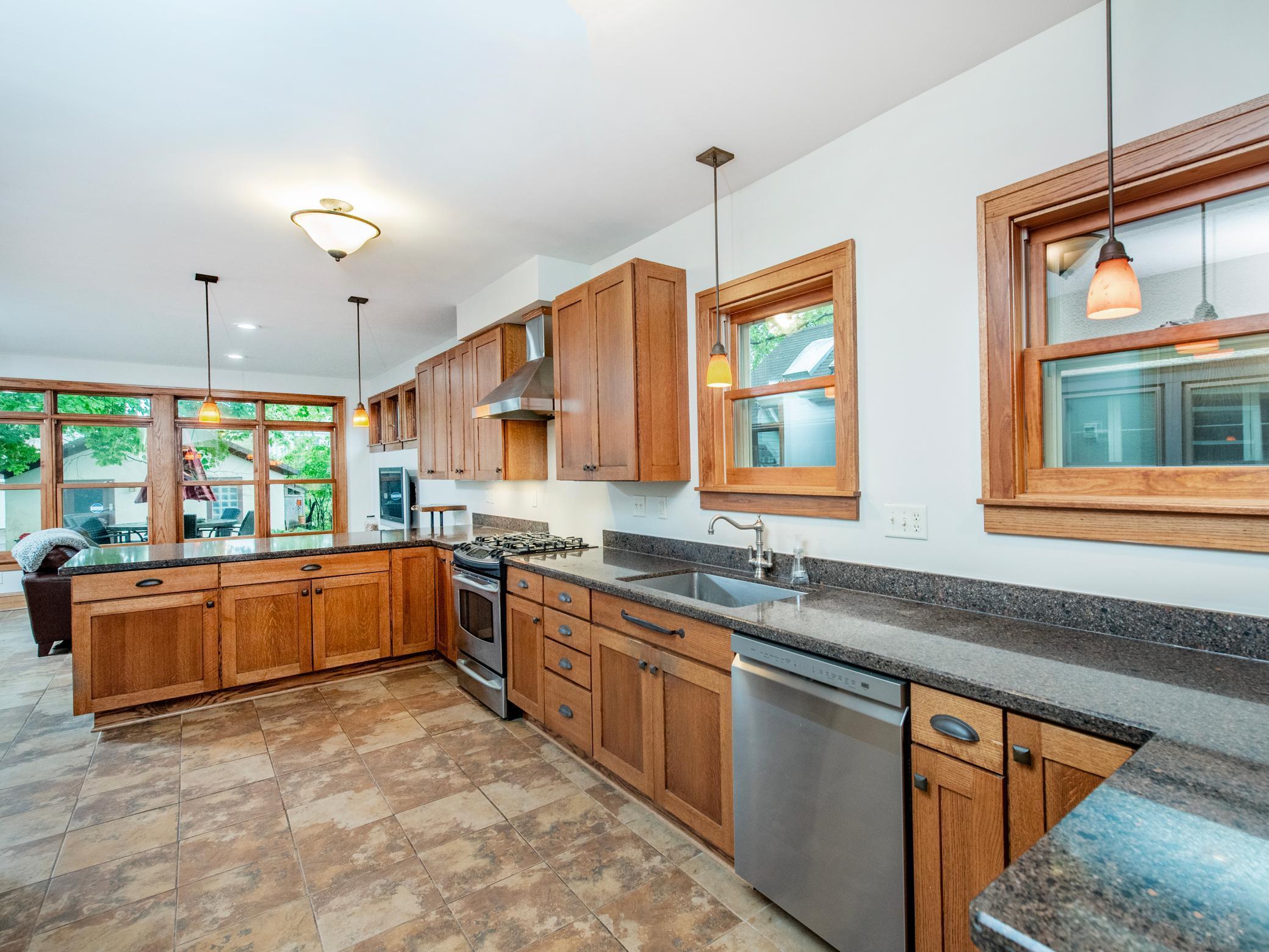 Spacious and functional kitchen features tile flooring, granite countertops, stainless steel appliances and a walk-in pantry.