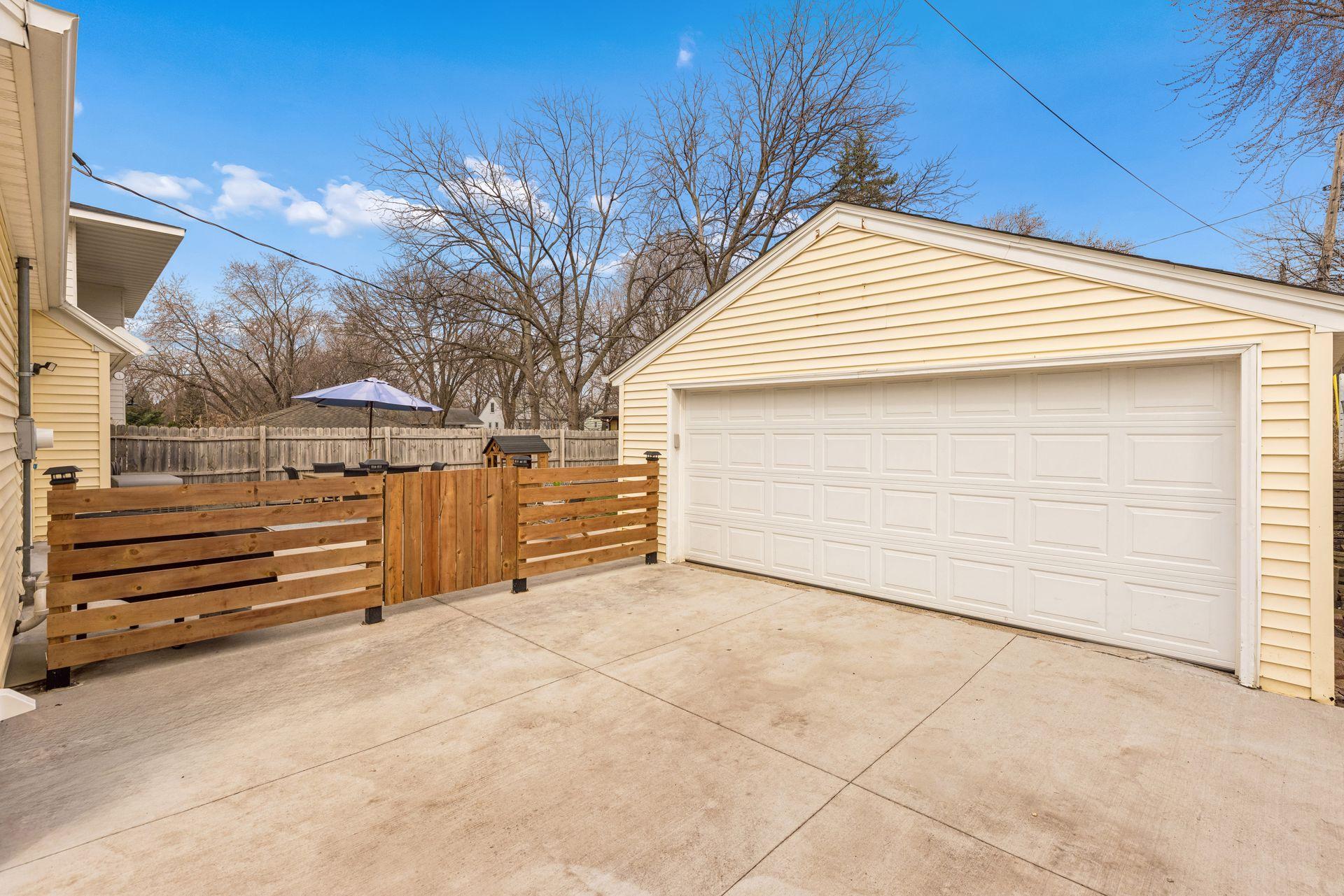 Garage w new door and new concrete driveway