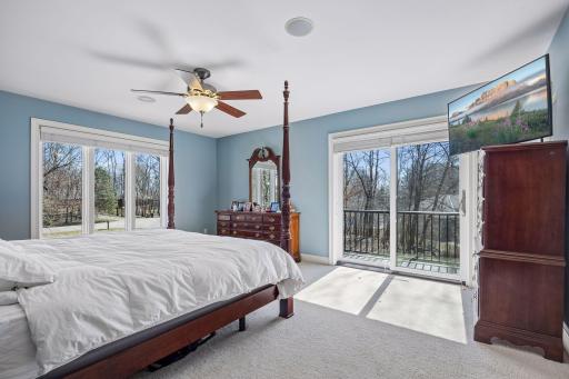 Upper level primary bedroom with its' own deck. Beautiful natural light and big room for plenty of space.