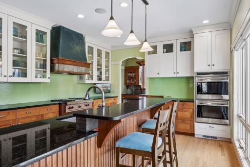 Close up of the center island to feature the granite countertops that add such unique character to the kitchen. Featuring double ovens even more kitchen storage.