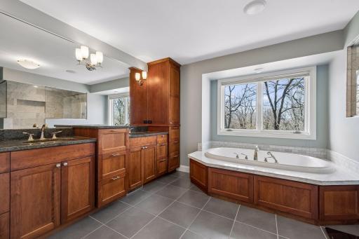 Primary bathroom that has double sinks and a great amounts of cabinets!