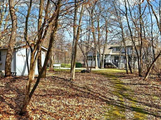 Backyard view where you can see the sport court that can also be transformed to another garage because of the concrete slab.