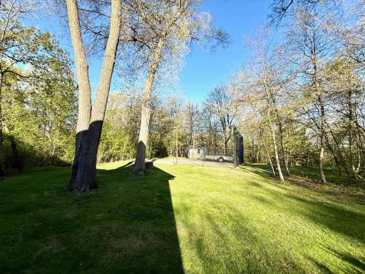 Fabulous backyard features a basketball court, which could also serve as foundation for outbuilding, etc.