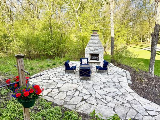 Patio in the backyard with fireplace that has a great space for seating options. Sit and enjoy the views!