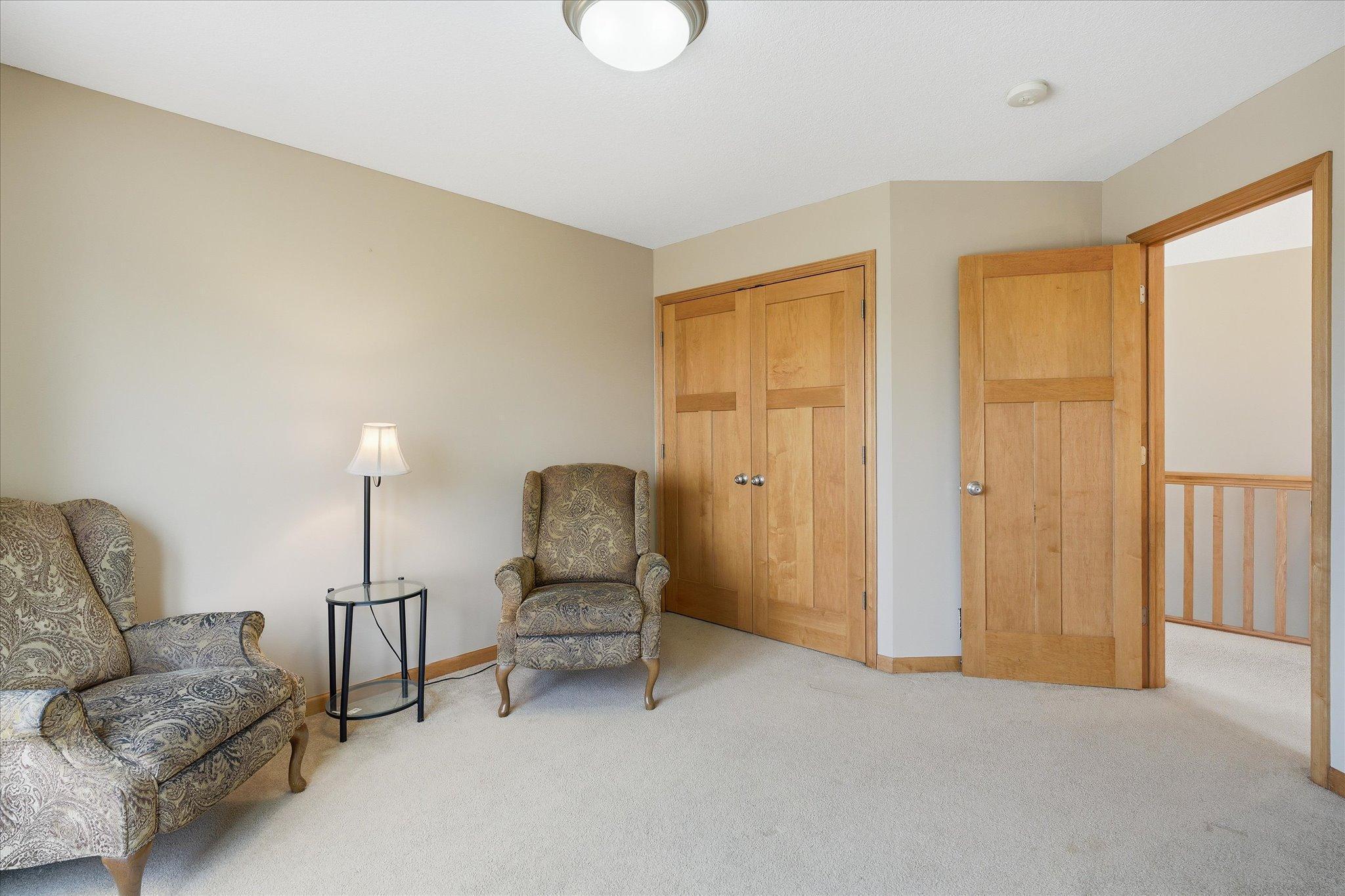 Second bedroom on upper level with paneled doors and large closet.