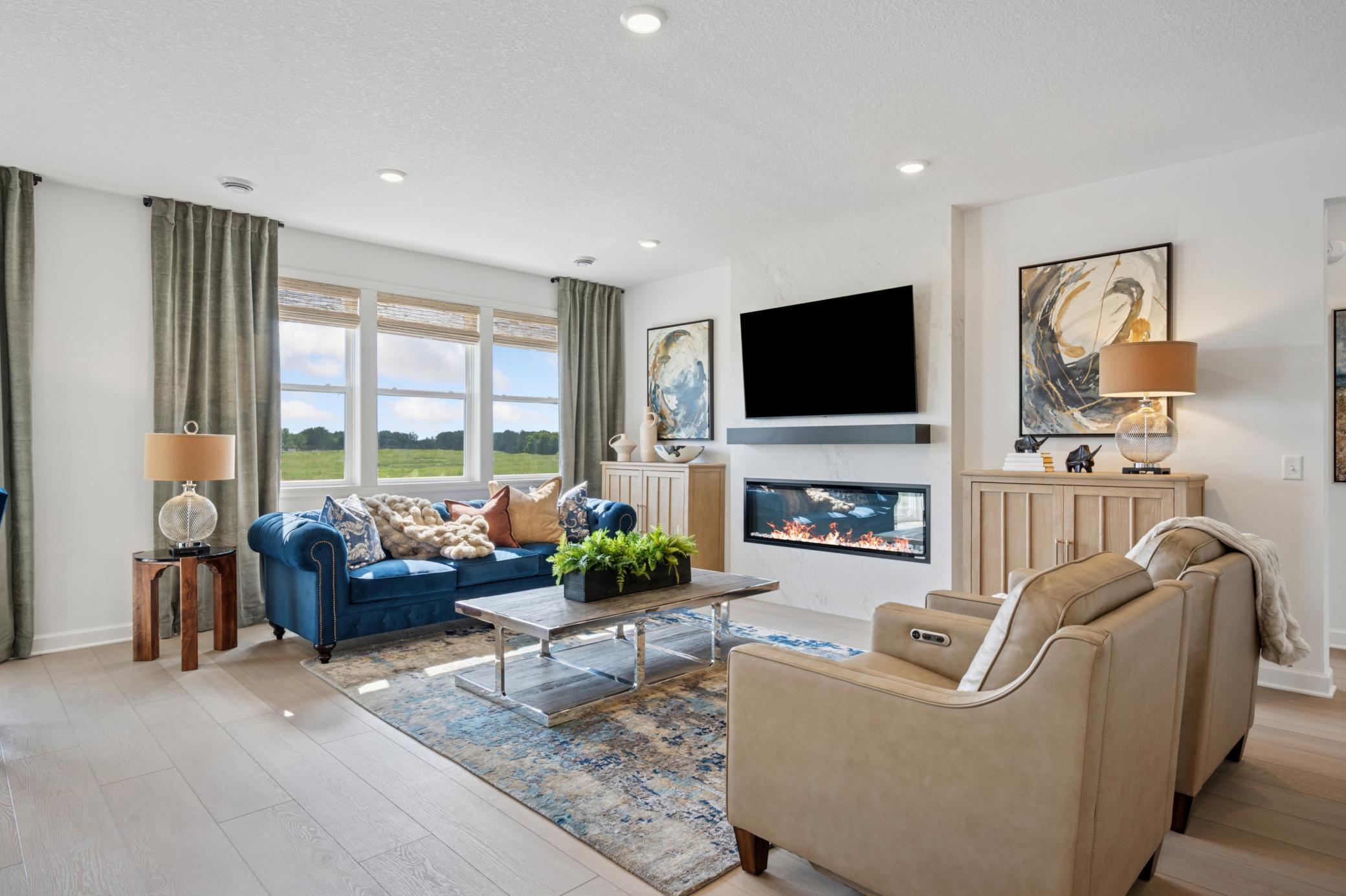 (Photo of a decorated model, actual homes finishes will vary) Cozy up next to the fireplace!
