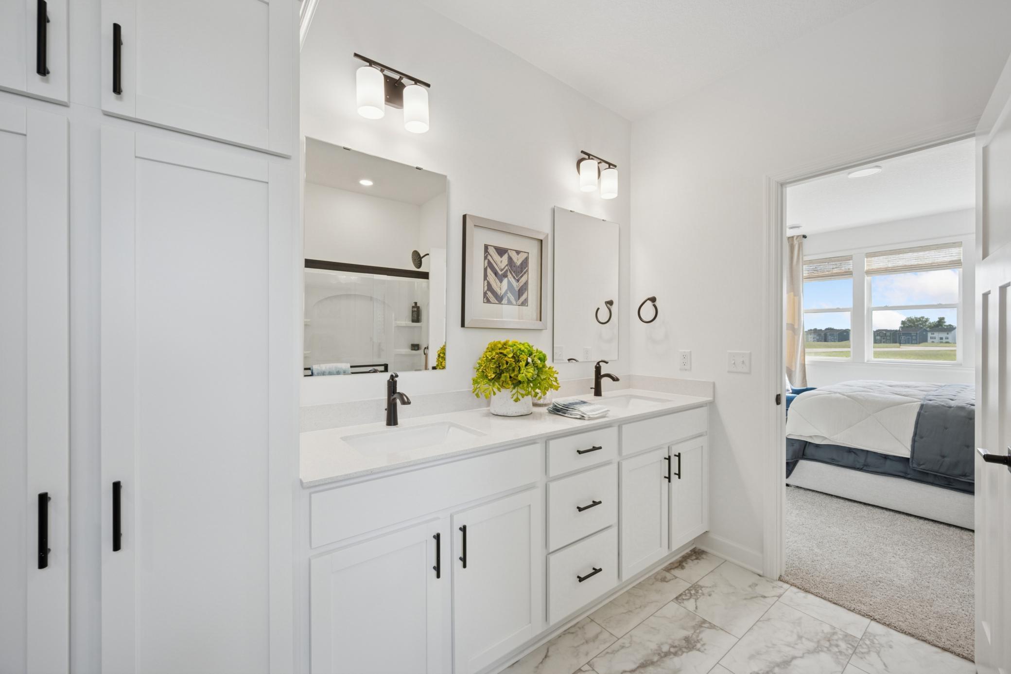 (Photo of a decorated model, actual homes finishes will vary) An extension of the primary bedroom, is this stunning bath!