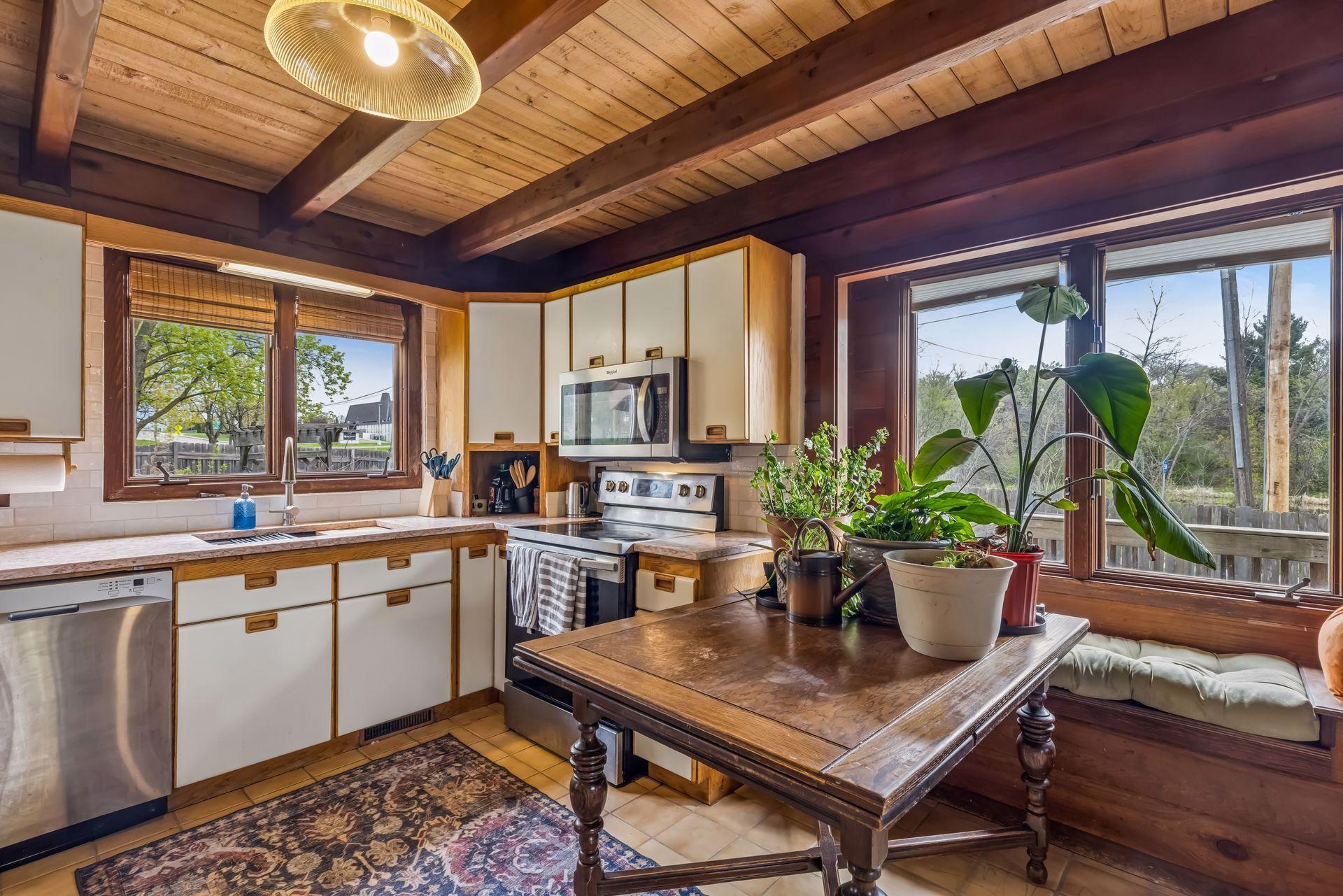 A quant dining nook with sun bench offers scenic views of the backyard.