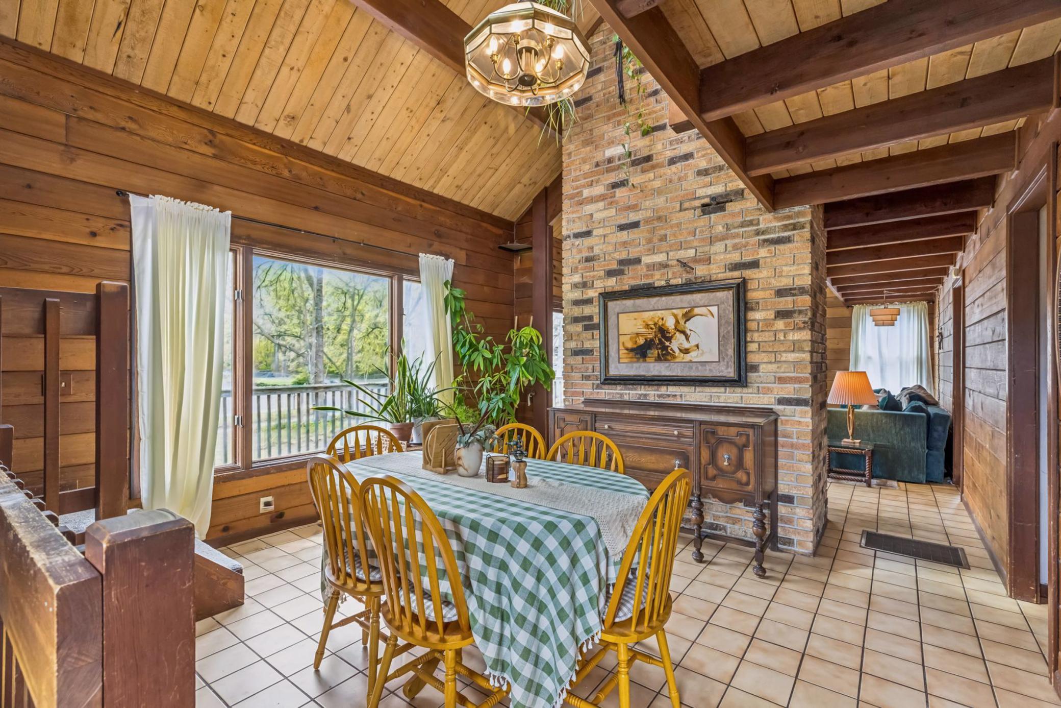The separate dining room shares the brick fireplace and offers a large south facing picture window.