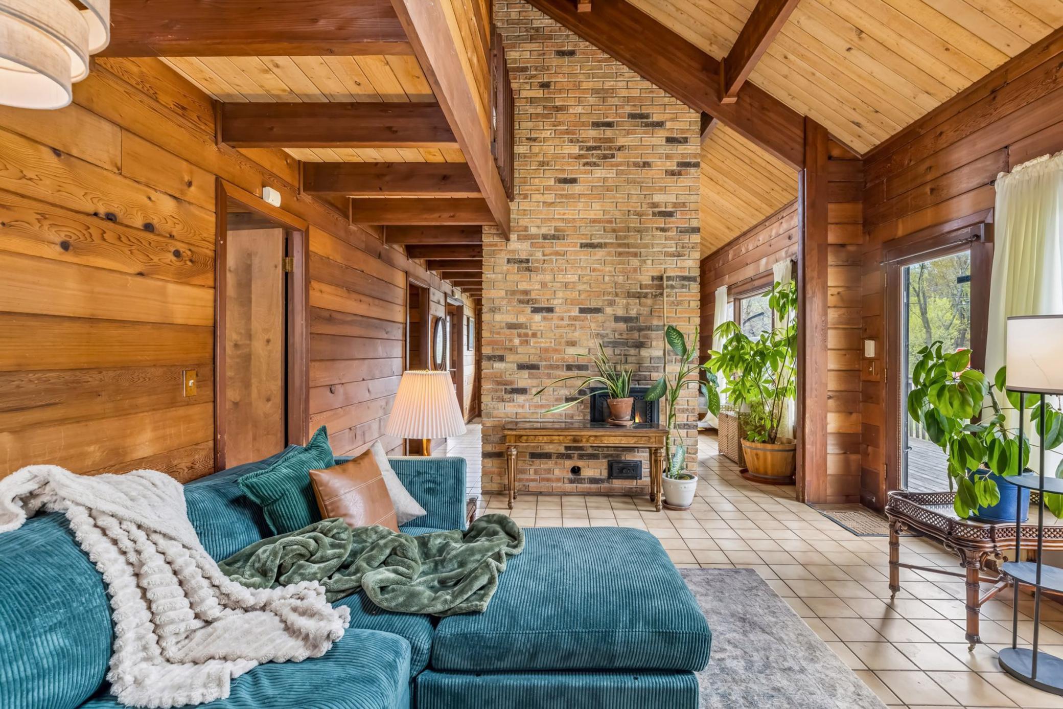 The vault and beam architecture provides structural integrity, bright airy spaces, and rich character. The brick floor to ceiling wood burning stove is a the central focus of the living room.