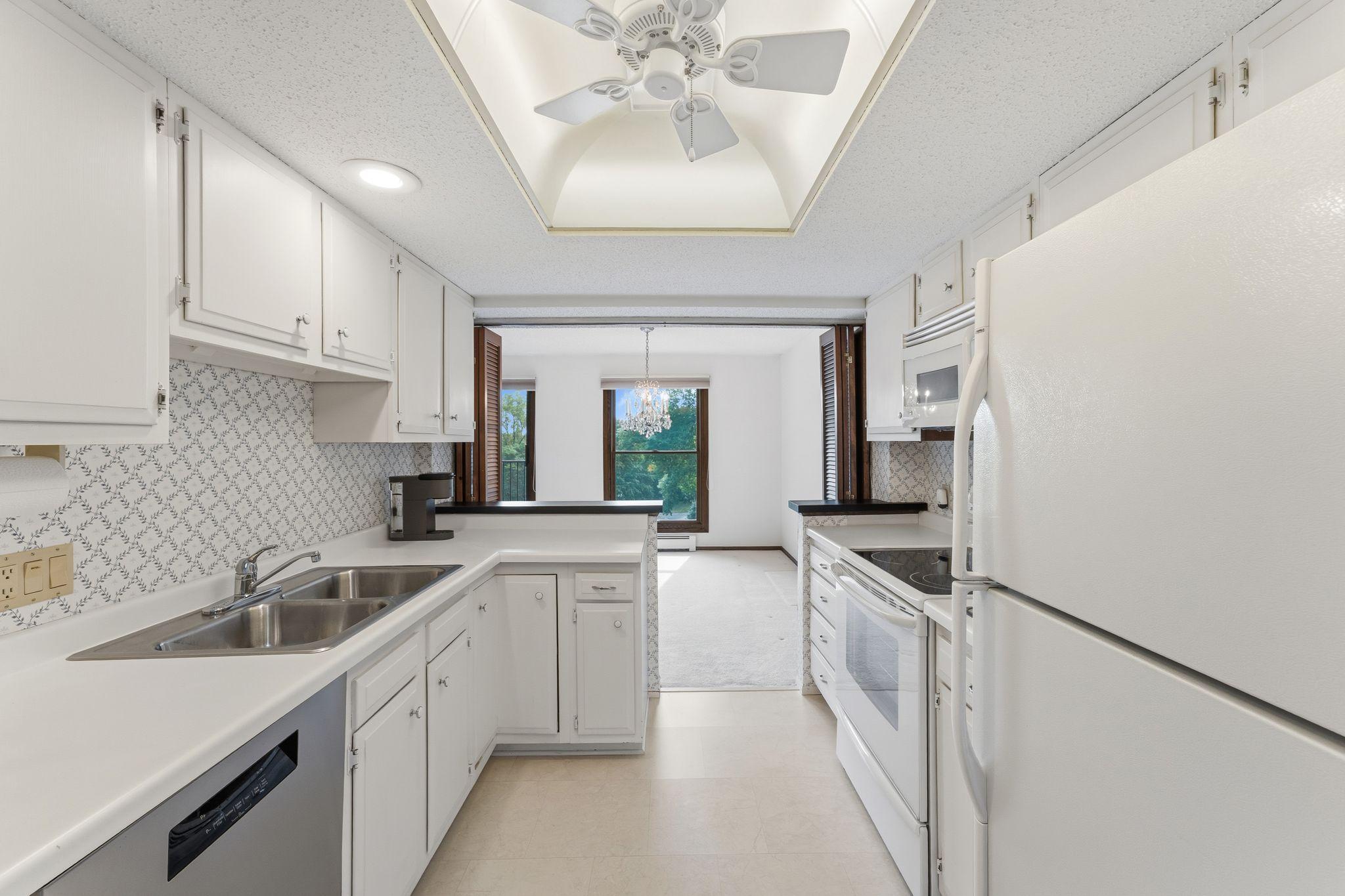 The kitchen offers ample cabinets and counter space