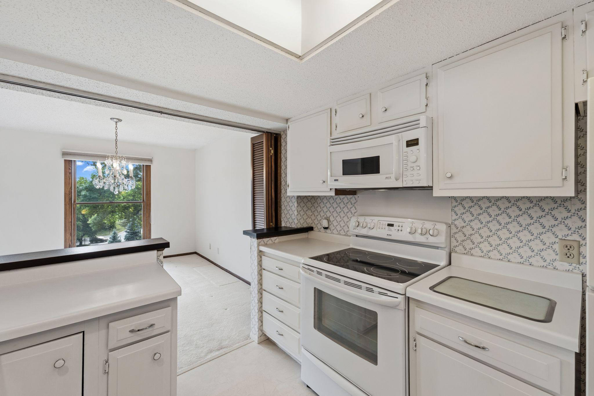 The bright, white kitchen is airy and light.