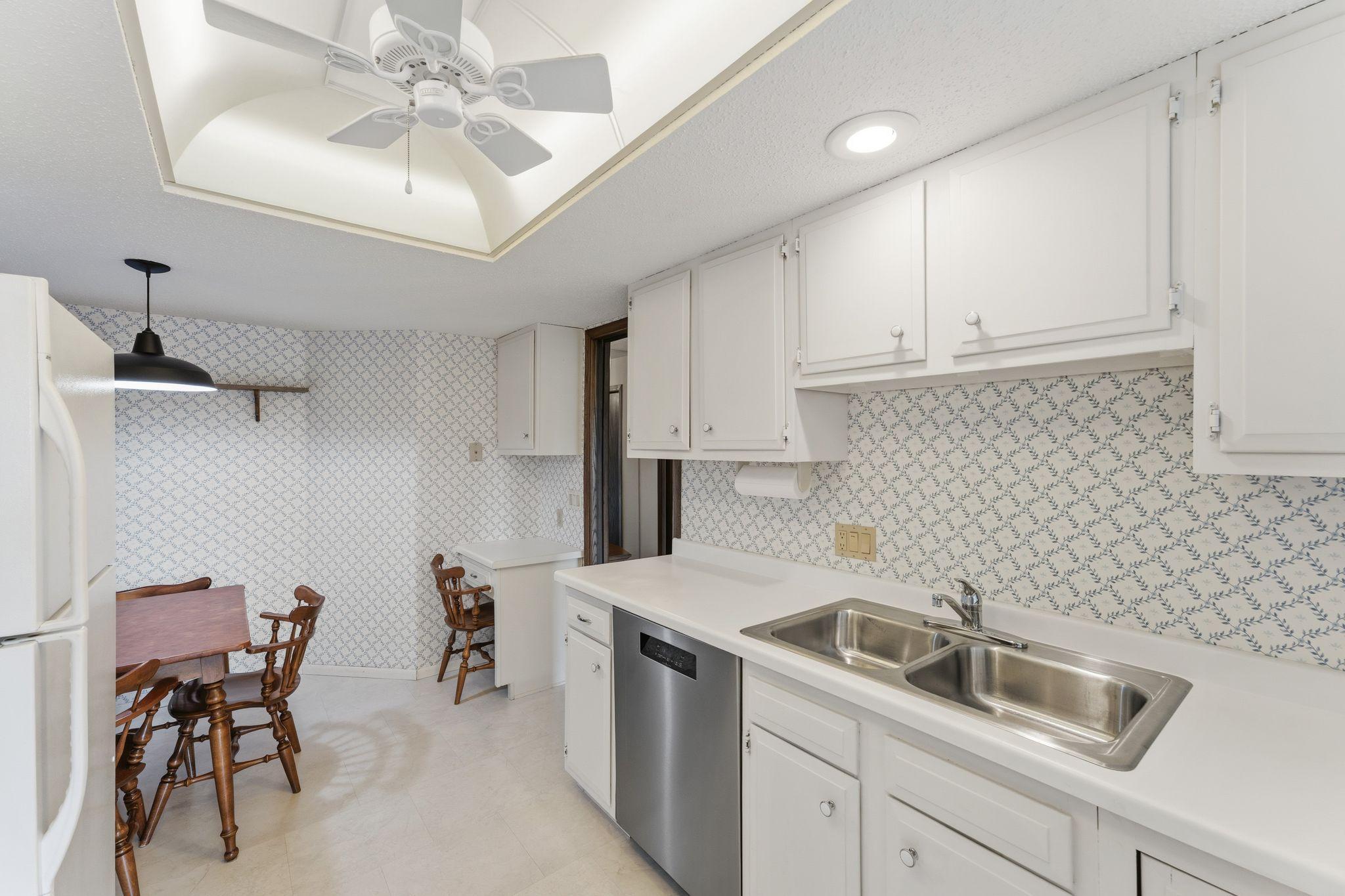 The kitchen features an eat in dining space and work desk.