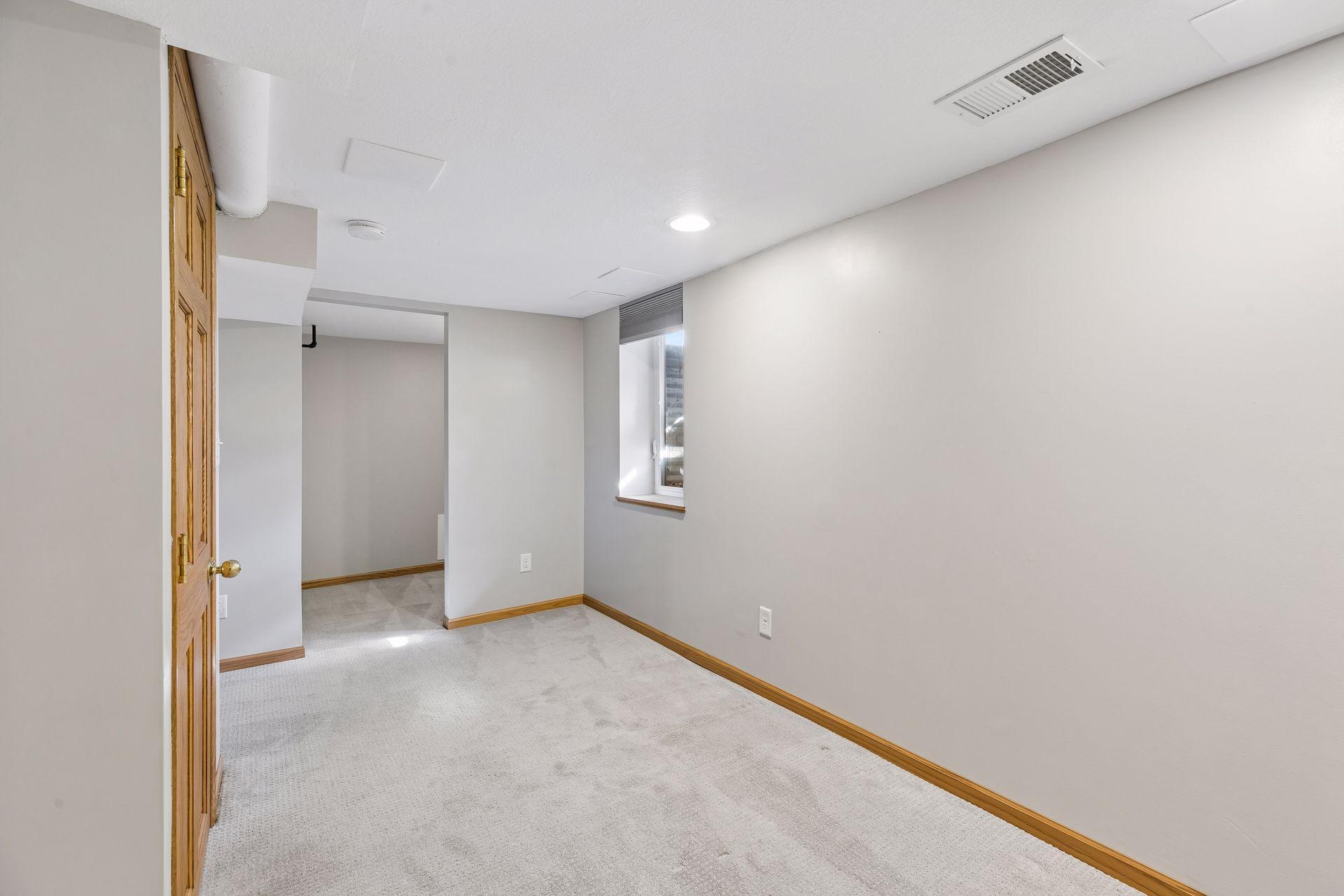 Egress window & walk-in closet in this lower level bedroom.