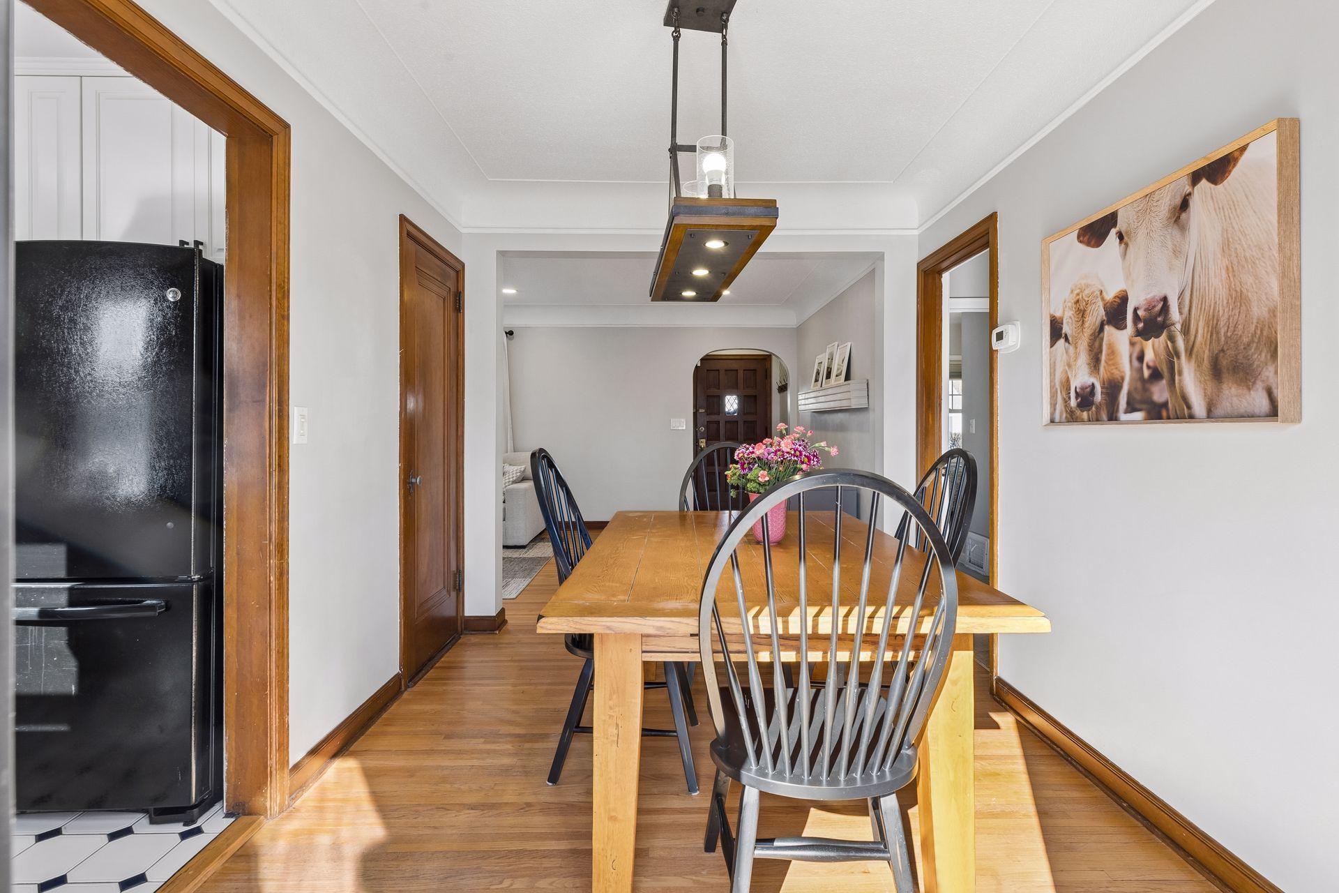 Alternate view of dining room with continued coved ceilings & updated light fixture.