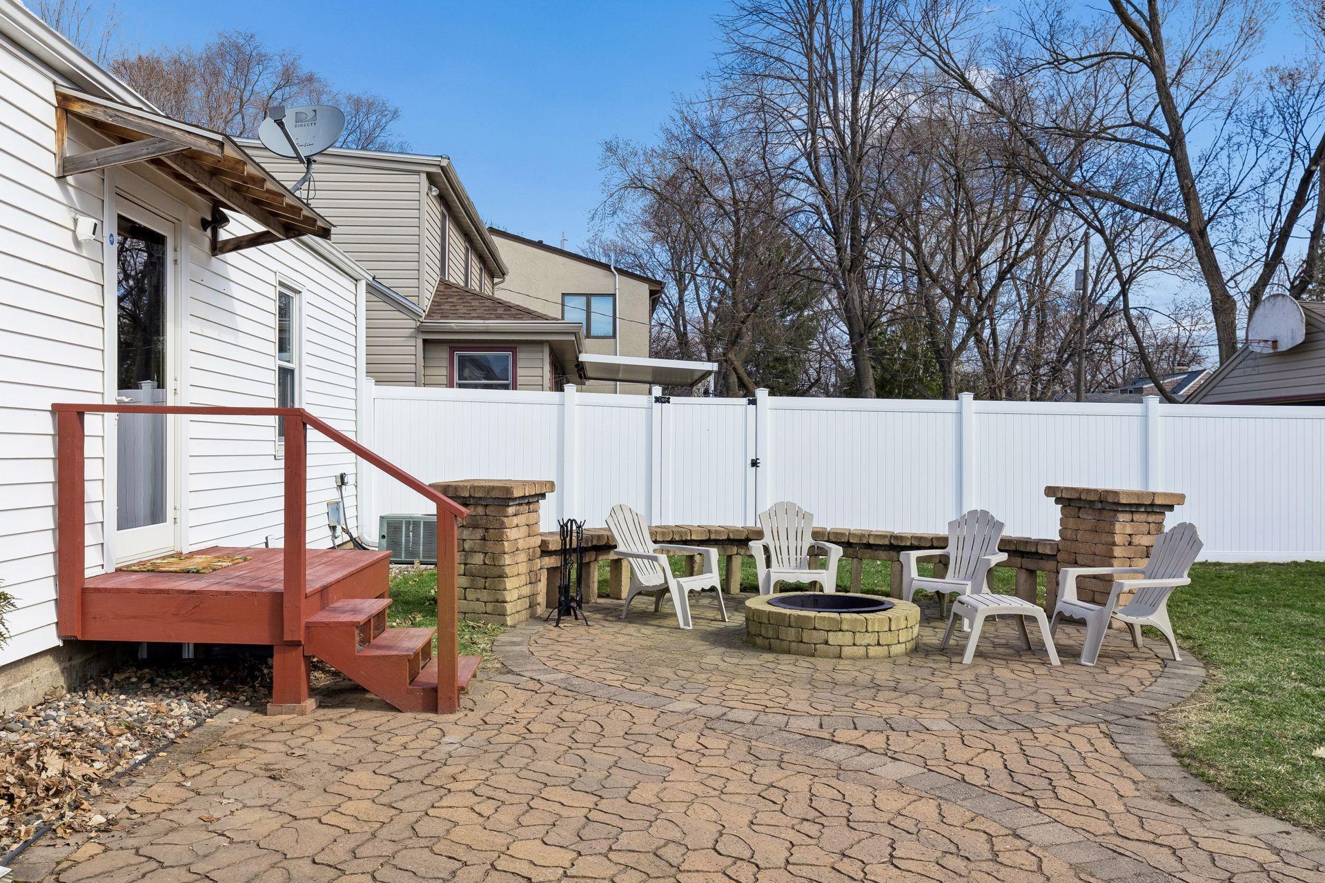 Welcoming paver patio & fire pit with built-in seating just in time for summer nights!