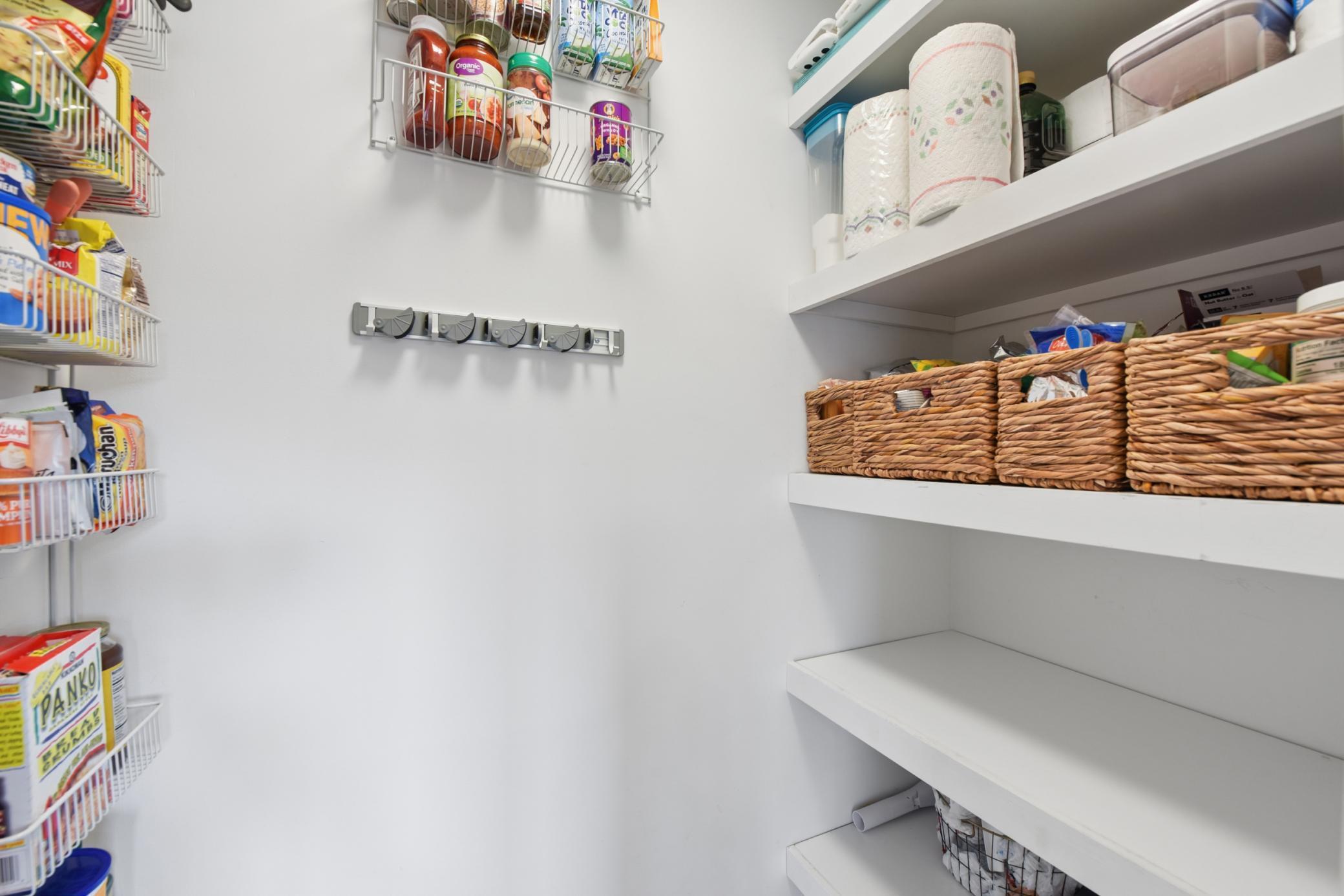 The pantry includes shelving and built-ins, offering storage and space for all your kitchen essentials.