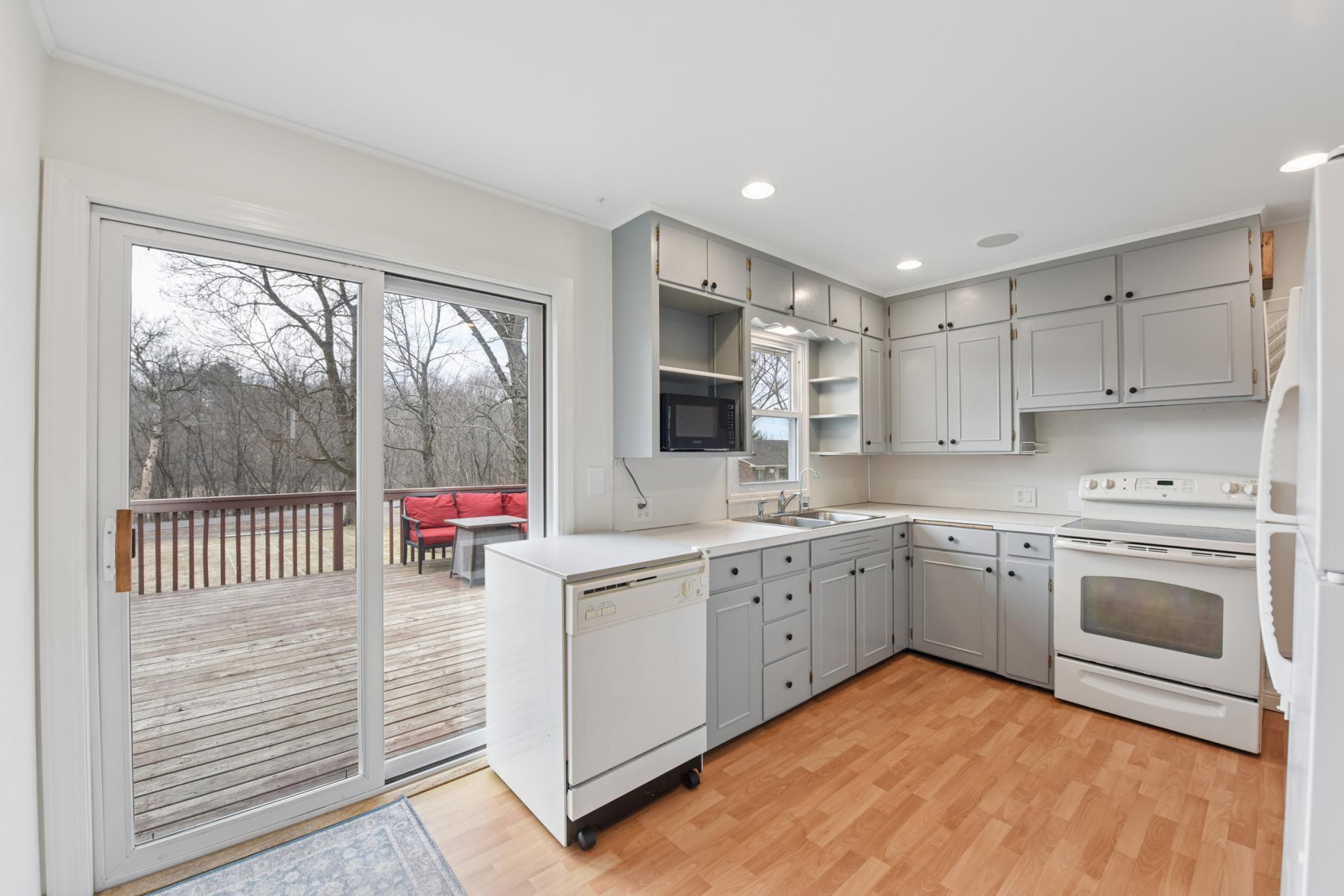 Cheerful kitchen with a patio door leading to the large back deck.
