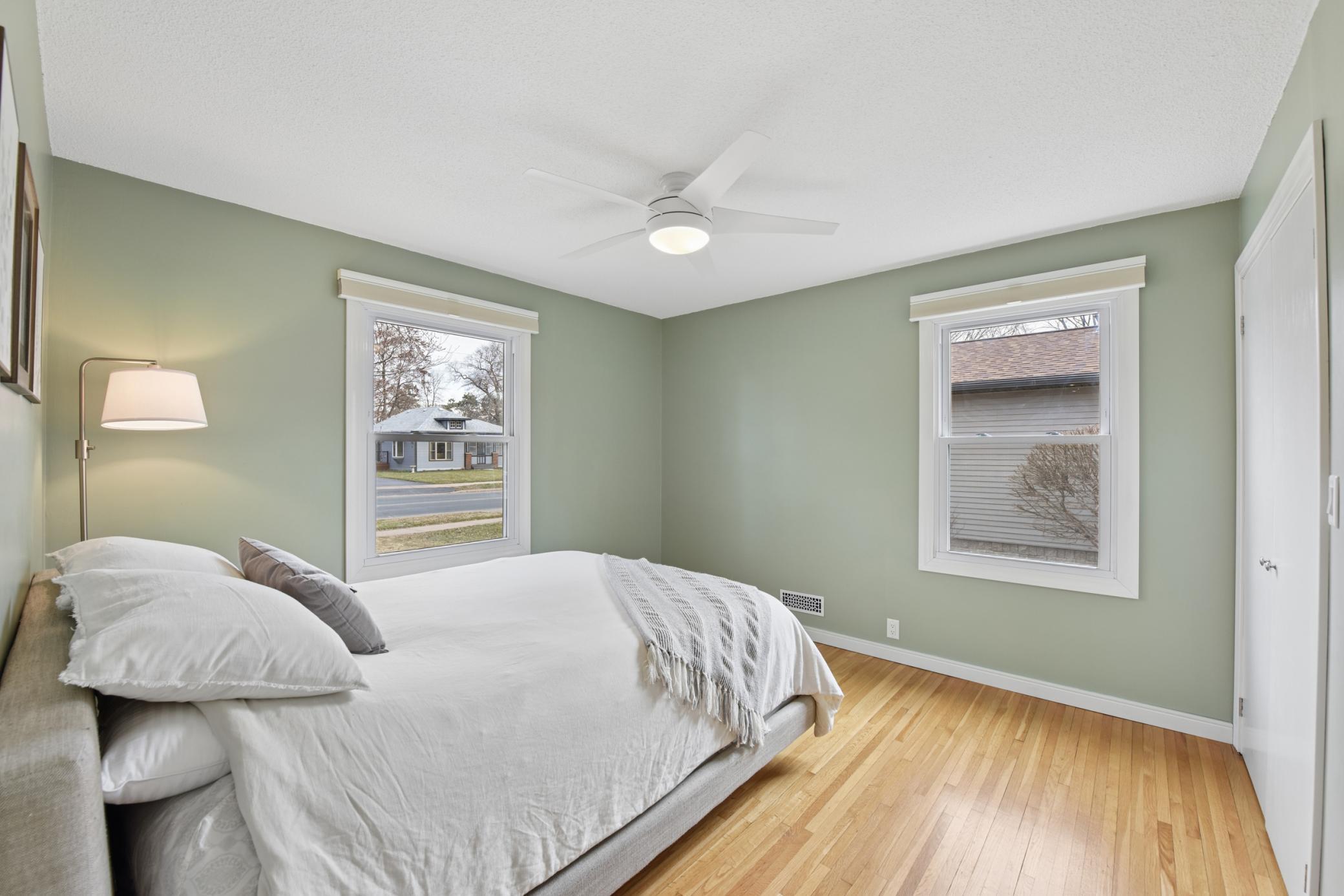 One of two main floor bedrooms with 2 windows, hardwood floor and closet built-ins.
