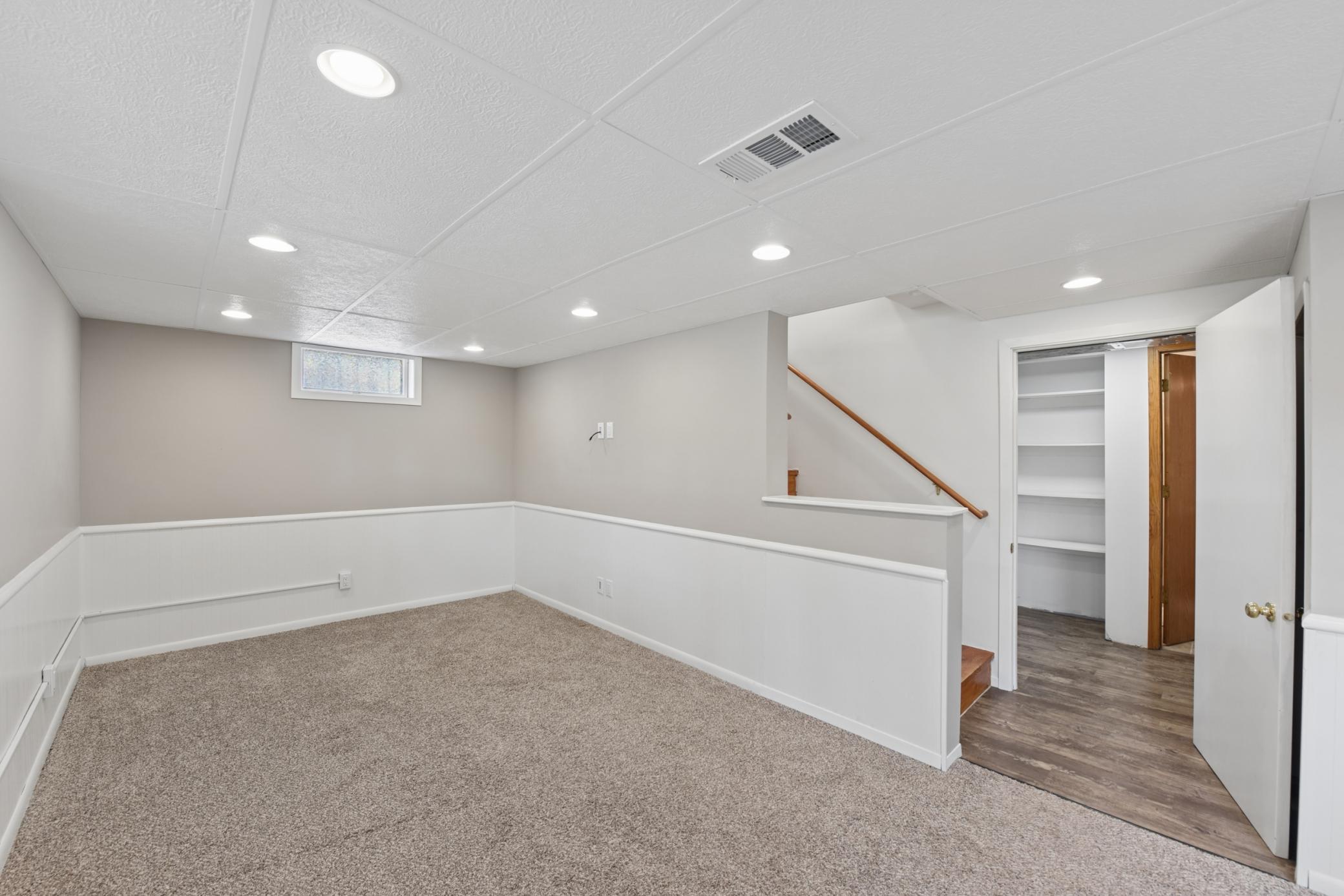 The lower level family room offers the perfect space to relax or entertain guests.