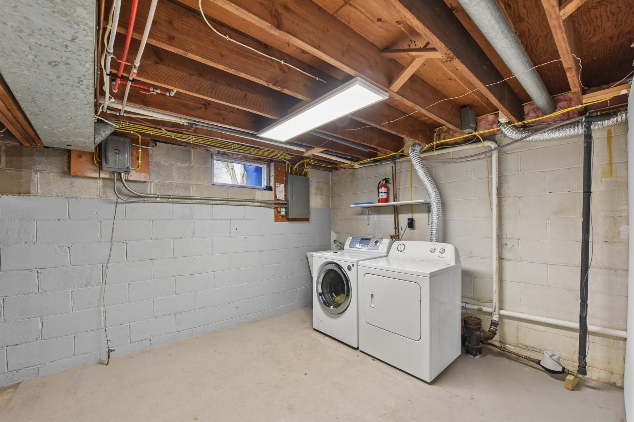 Lower level laundry room with plenty of space for storage.