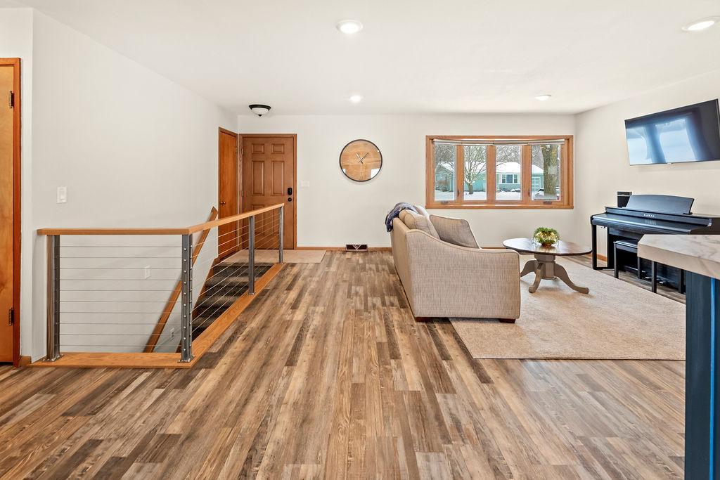 Open-concept living. Modern staircase. Welcoming front entry.