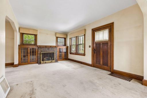 Step inside to discover beautiful woodwork, hardwood floors and custom built-ins that highlight the inviting living room, creating a cozy yet distinctive space.