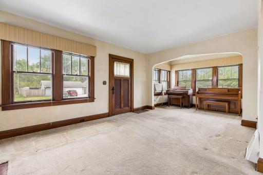 Additional main-level room just off the living area offers flexibility as a home office, music room, or creative space.