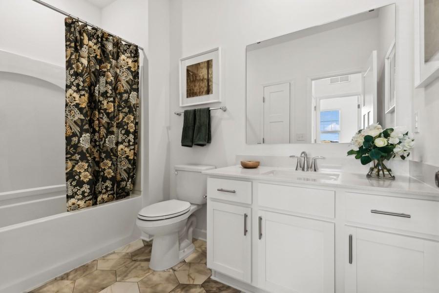 (Photo of a decorated model, actual homes finishes will vary) The spacious upper level secondary bath.
