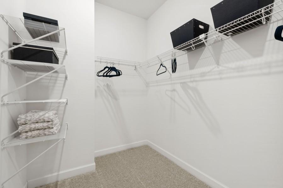 (Photo of a decorated model, actual homes finishes will vary) The primary bedroom features an incredible walk-in closet.