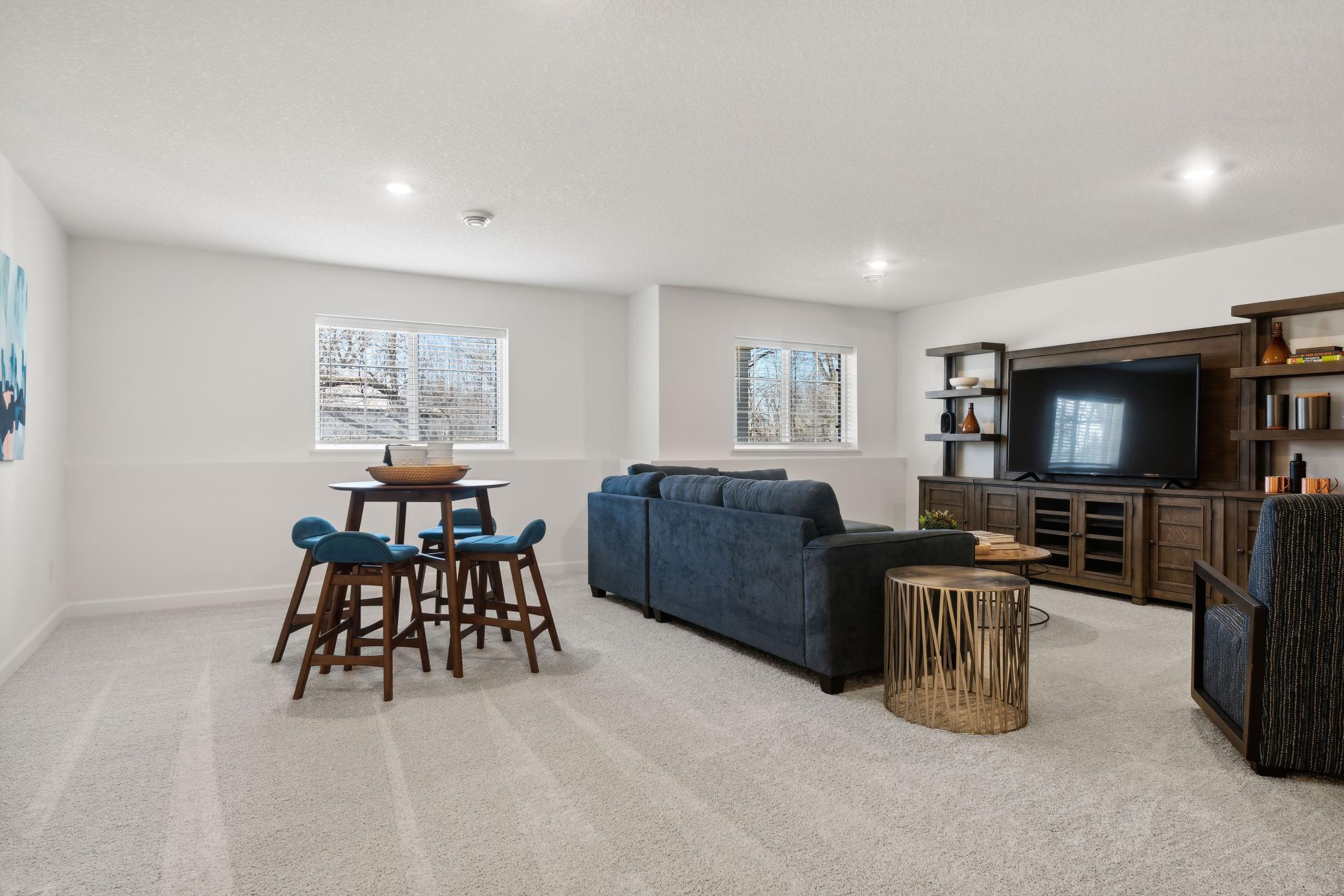 (Photo of a decorated model, actual homes finishes will vary) The spacious recreation room.