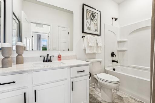 (Photo of a decorated model, actual homes finishes will vary) The secondary bath.