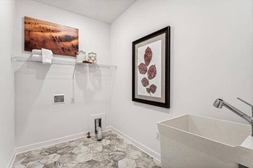 (Photo of a decorated model, actual homes finishes will vary) The laundry room.